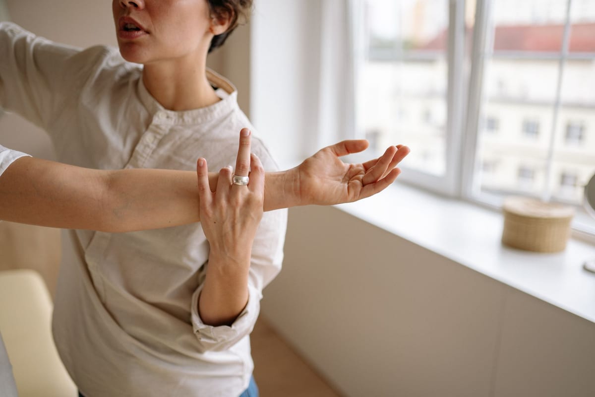 A therapist working through the muscles of a client's forearm and wrist