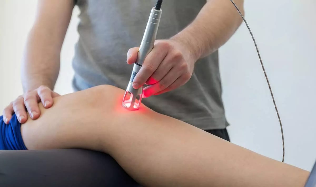 Class IV laser therapy being applied to a patient's knee